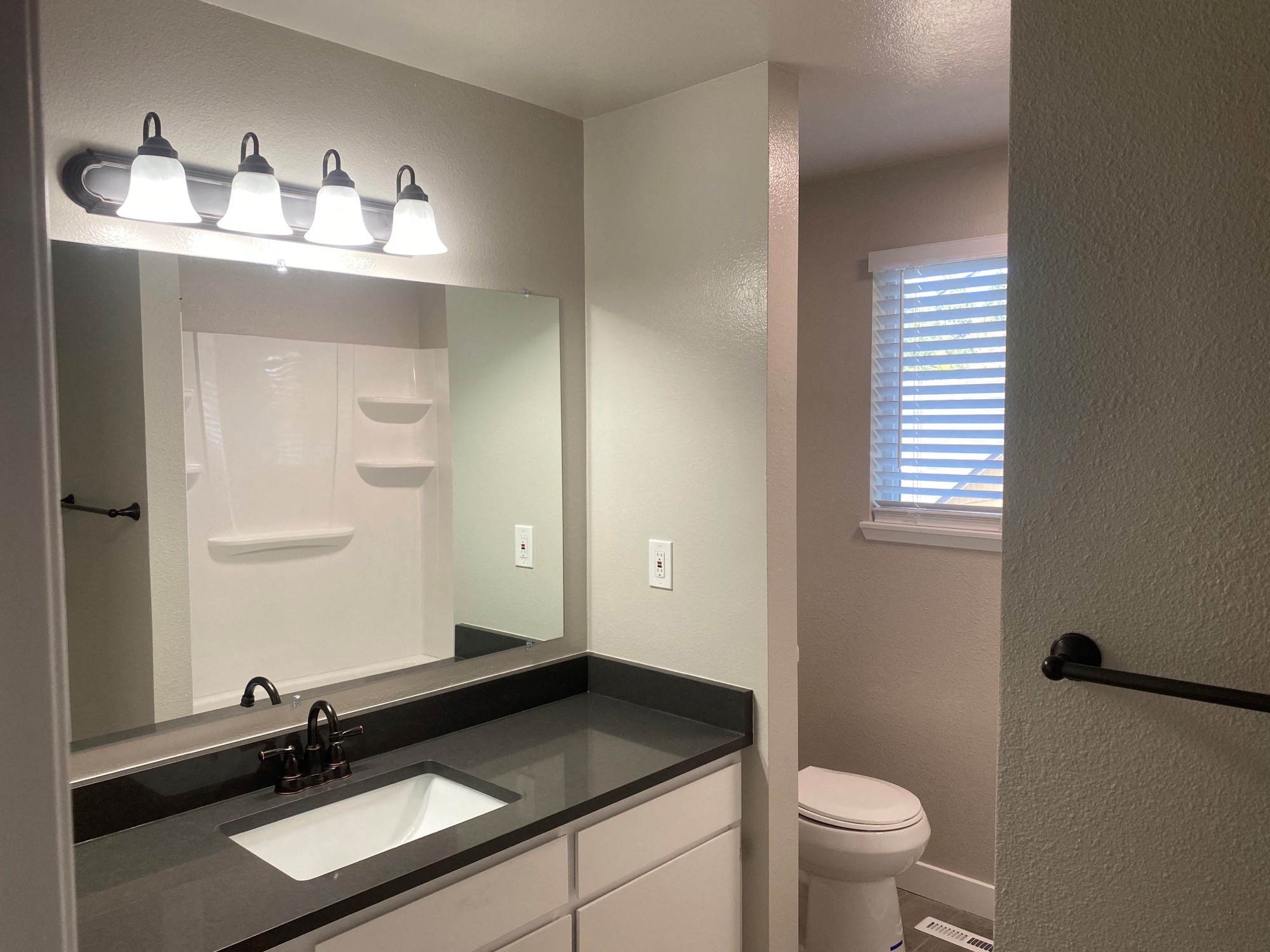 a bathroom with a sink and a toilet and a mirror